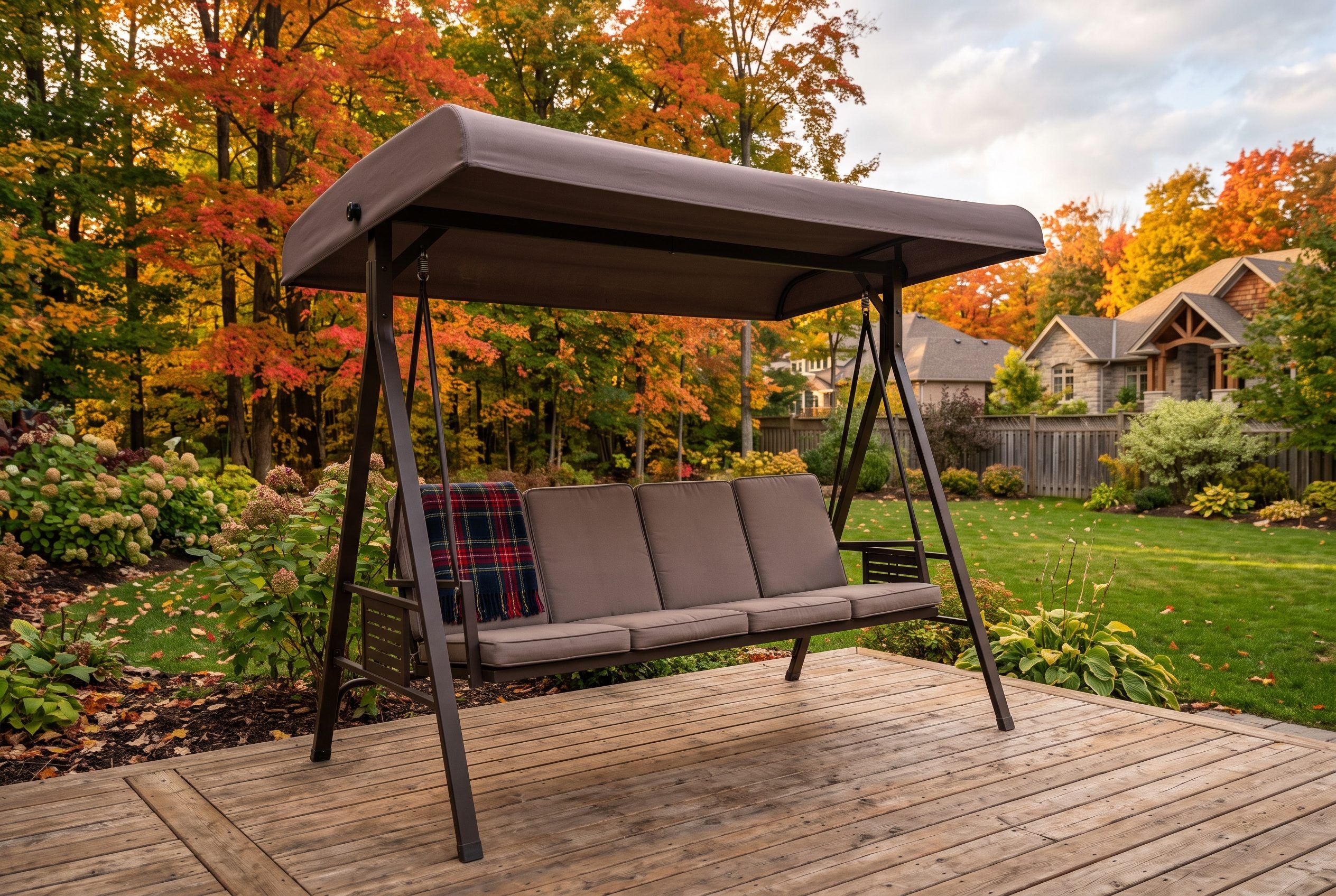 Four-seater garden swing with a canopy on a cedar deck in a Canadian backyard during autumn