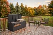 Steel outdoor storage box on an autumn deck with patio furniture and fallen maple leaves