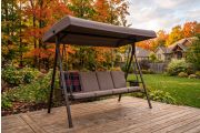 Canopy garden swing on a Canadian backyard deck surrounded by autumn maples