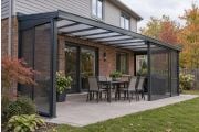 Wall-mounted gazebo with polycarbonate roof and mosquito screens on a Canadian backyard patio