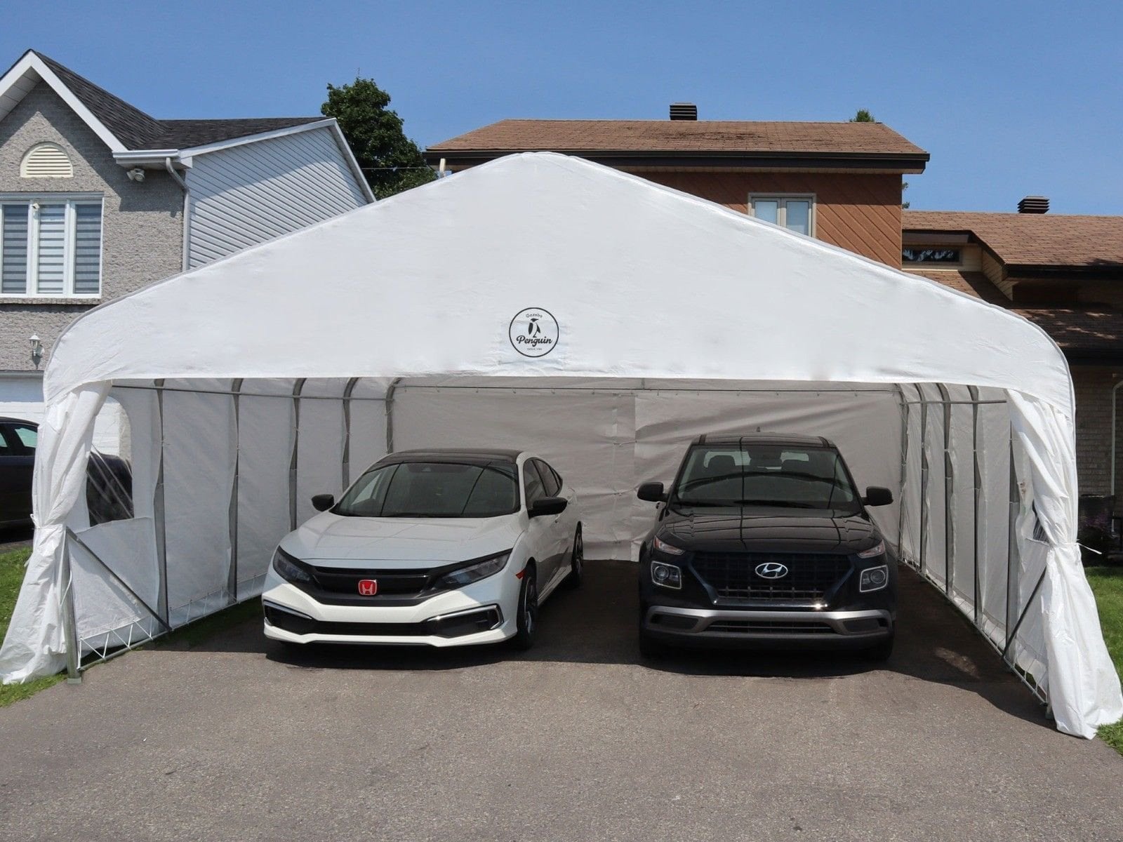 Gazebo Penguin double car shelter set up over two cars in a driveway